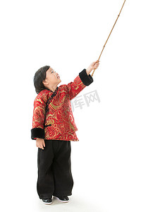 过新年的小男孩拿着竹竿玩耍