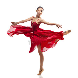 穿红色裙子跳芭蕾舞的青年女人