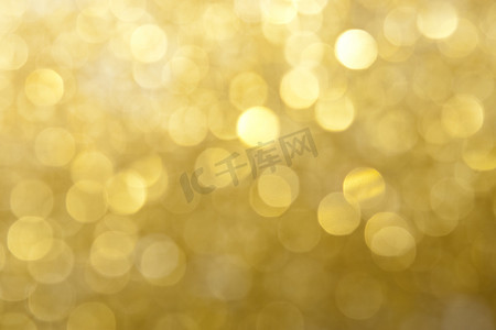 节日灯光摄影照片_金色和黄色闪闪发光的灯光背景