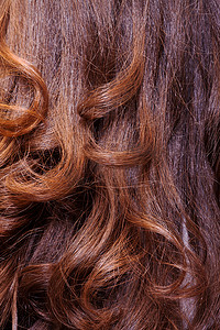旋度摄影照片_波浪赤褐色头发的背景
