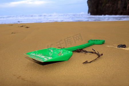 海滩上的绿色铲子
