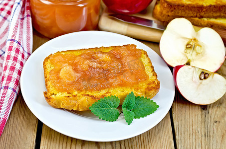 烤玉米水果摄影照片_板上有苹果酱和苹果的面包