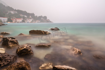 克罗亚达尔马提亚奥米斯附近岩石海滩的暴雨和雾