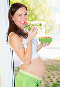 怀孕的女孩吃沙拉