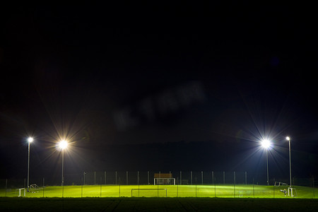 夏天院子摄影照片_空荡荡的足球场在夜间被照亮