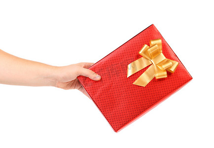 金斑点装饰摄影照片_有斑点和金色蝴蝶结的红色礼物盒。
