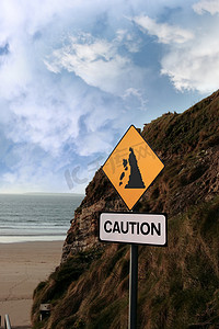 土石塌方摄影照片_海滩滑坡警告标志