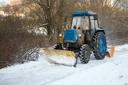 拖拉机沿着积雪的道路行驶