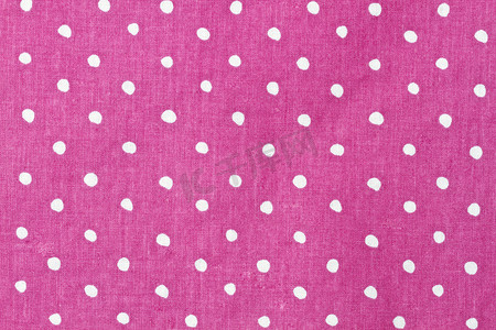 粉色和白色圆点织物背景