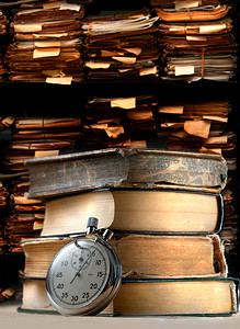 机械时间表摄影照片_一堆旧书和秒表