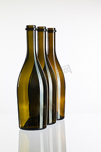 干杯液体摄影照片_玻璃桌上的空酒瓶