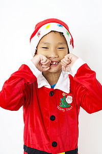 圣诞帽绿色摄影照片_白色背景中戴着红色圣诞帽的亚洲小男孩