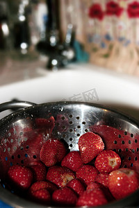 厨房漏勺里成熟的红草莓
