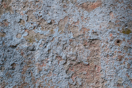 剥落的油漆摄影照片_在混凝土墙上的老剥落的石膏，剥落的油漆，蓝色纹理，背景