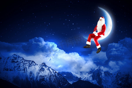 圣诞老人轮廓摄影照片_坐在月亮上的圣诞老人照片