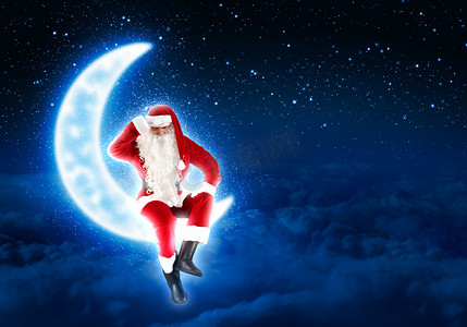 坐在月亮上的圣诞老人照片