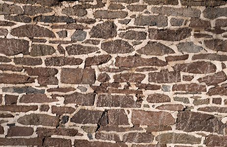不规则图圈摄影照片_使用不规则石头的旧砖石墙