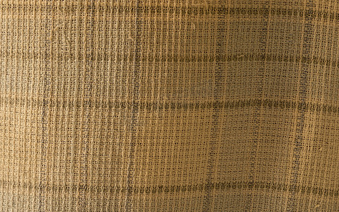 皱纹织物质地的特写，亚麻布纺织背景的轻质织物与纵横交错的波浪。