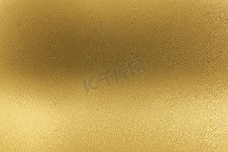 背景青铜纹理摄影照片_抽象纹理背景，发光的金黄金属墙壁