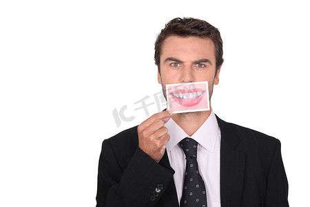 漫画女摄影照片_商人拿着一张女人嘴巴的照片代替他的 Dubbroca_Joffrey_160410