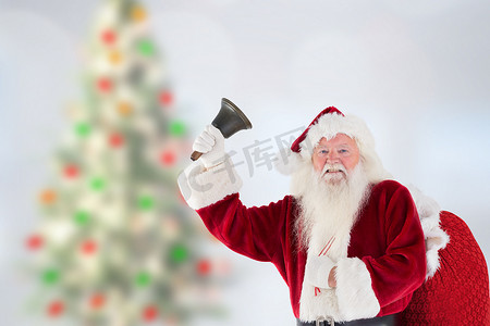 响铃摄影照片_拿着礼物袋和响铃的圣诞老人