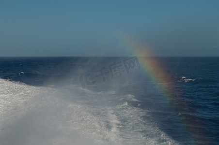 一艘船留下的尾迹和彩虹。