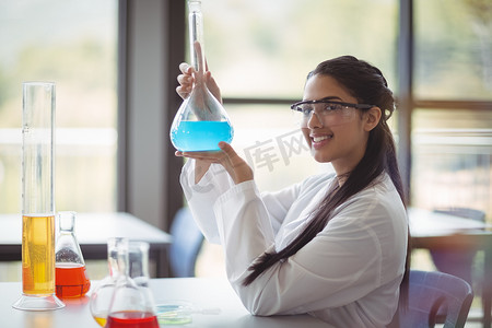在实验室做化学实验的快乐女学生的画像