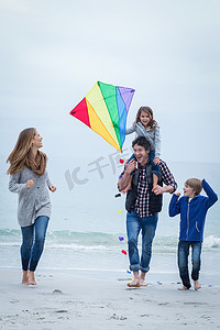 在海边放风筝的幸福家庭