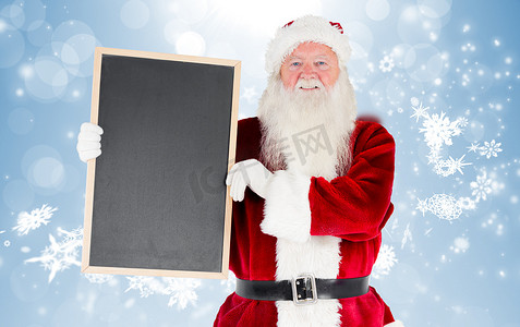 蓝色雪花图摄影照片_显示黑板的圣诞老人的合成图象