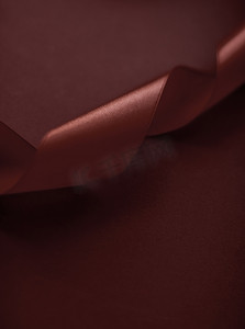 巧克力背景上的抽象丝带、假日销售产品促销的独家奢侈品牌设计和魅力艺术邀请卡背景