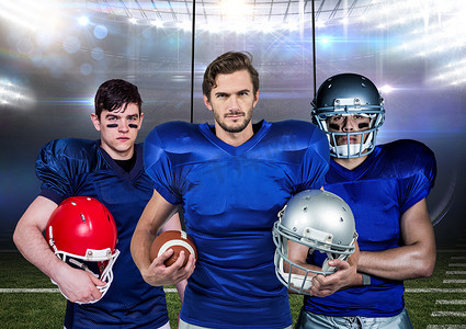 美国橄榄球运动员在背景中拿着头盔和球对抗体育场