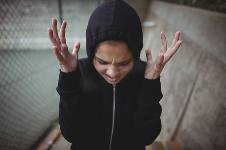 女学生站立摄影照片_站立在学校校园的恼怒的十几岁的女孩