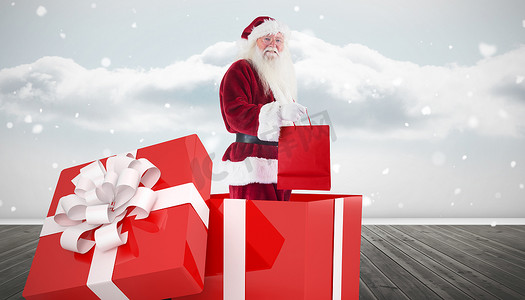 抵扣大礼包摄影照片_圣诞老人站在大礼物中的合成图像