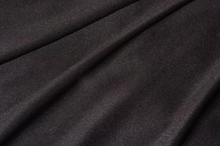 黑色缎面纺织面料折叠特写