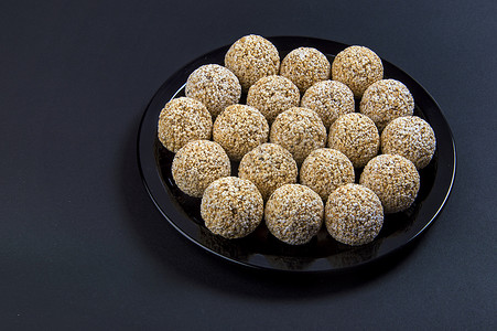 黑色背景的黑色盘子中的苋菜 ladoo 或 Rajgira laddu 或 Cholai ke laddu。