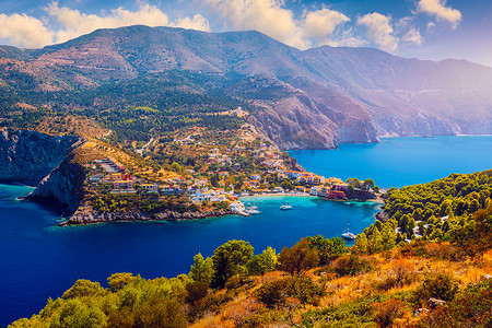 地中海绿松石色的海湾，在希腊凯法利尼亚的 Assos 村有美丽的五颜六色的房子。 