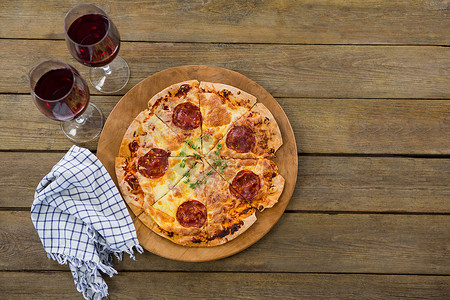 意大利比萨饼放在比萨饼托盘中，配红酒
