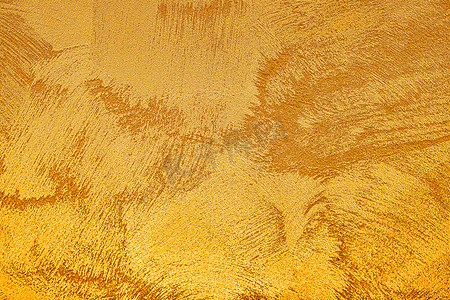 金色划痕背景摄影照片_金色装饰石膏或混凝土的质地。