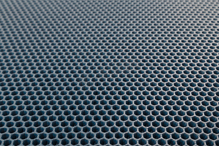 蓝色六角形穿孔 EVA-乙烯醋酸乙烯酯泡沫地毯线性透视背景，有选择的焦点