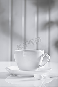 有匙子的陶瓷咖啡杯在白色