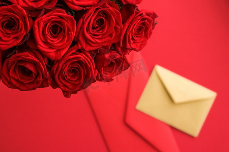卡片手绘花边摄影照片_情人节的情书和送花服务、豪华的红玫瑰花束和红色背景的卡片信封