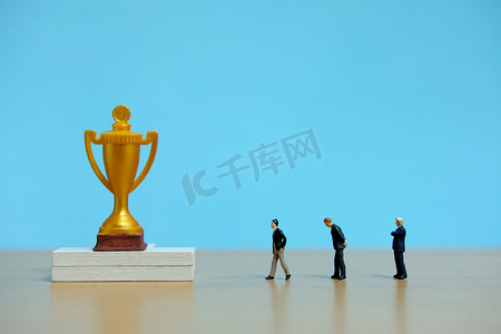 微型商业概念 — 一群商人在金色奖杯后排队