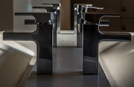 有镀铬物水龙头和白色铺磁砖的现代卫生间水盆。