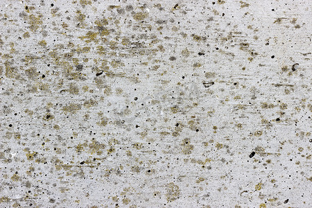 混凝土质感摄影照片_平坦的灰色混凝土表面，有浅褐色的地衣斑点