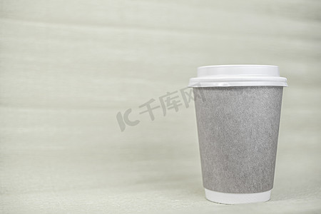纸杯咖啡用黄色背景上的白色盖子封闭。