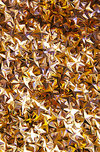 金色五彩纸屑点缀着节日明亮的背景或圣诞节或新年派对装饰