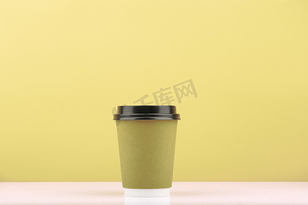浅卡其色背景、带复制空间的白桌热饮一次性茶或咖啡杯