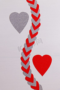 红色和银色的心与带纹理的白色心串分开