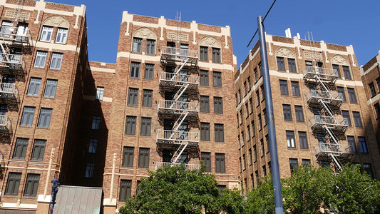 逃生窗户摄影照片_美国圣地亚哥市住宅砖砌建筑外的消防梯。