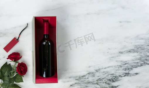 情人节快乐，在天然大理石的礼盒里放着可爱的红玫瑰花和红酒